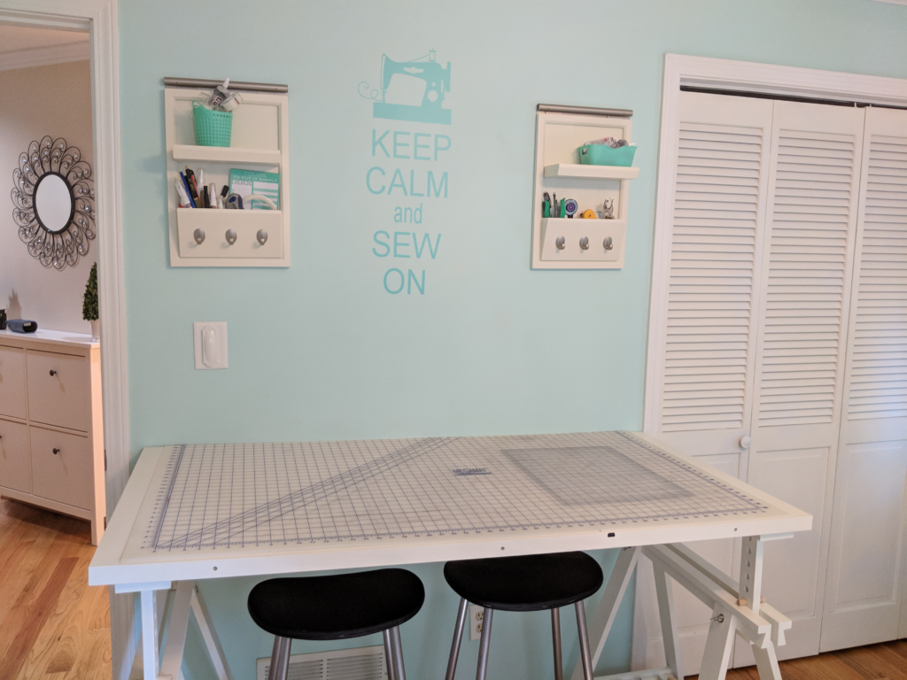 Mint green sewing room with cutting table